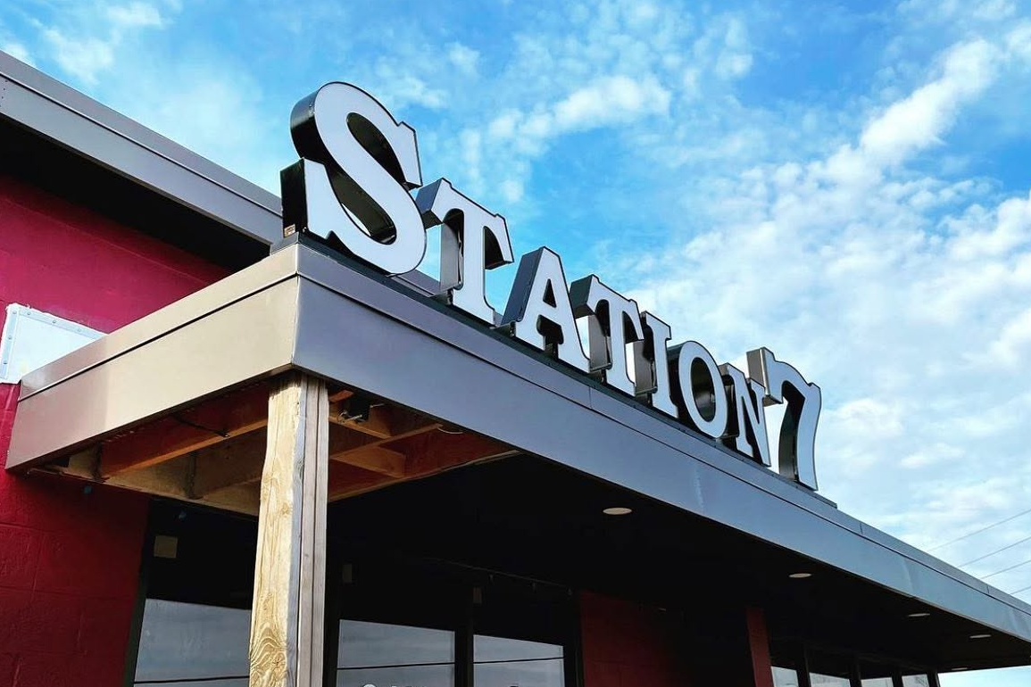 exterior of a red building with a sign that says station 7